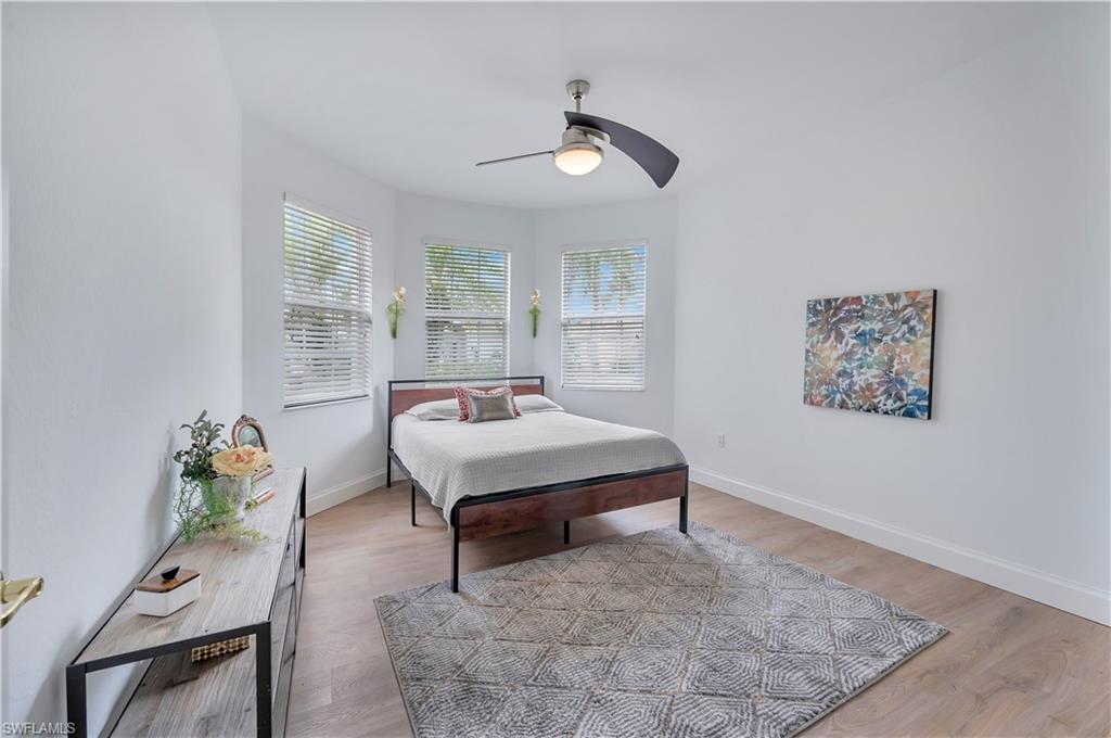 14095 Mirror Court Naples, FL 34114 - Photo 21 of 45 Bedroom featuring light wood-type flooring and a ceiling fan