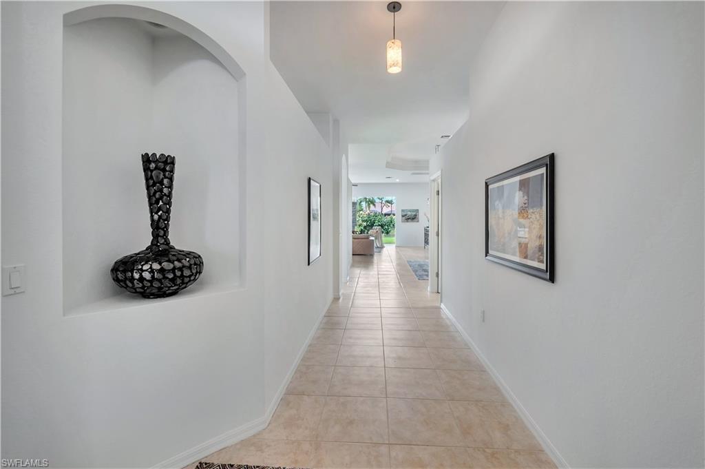 14095 Mirror Court Naples, FL 34114 - Photo 3 of 45 Hallway featuring light tile patterned flooring and baseboards
