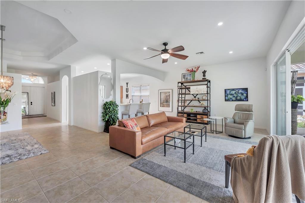 14095 Mirror Court Naples, FL 34114 - Photo 4 of 45 Living area with arched walkways, light tile patterned flooring, ceiling fan, recessed lighting, and a chandelier