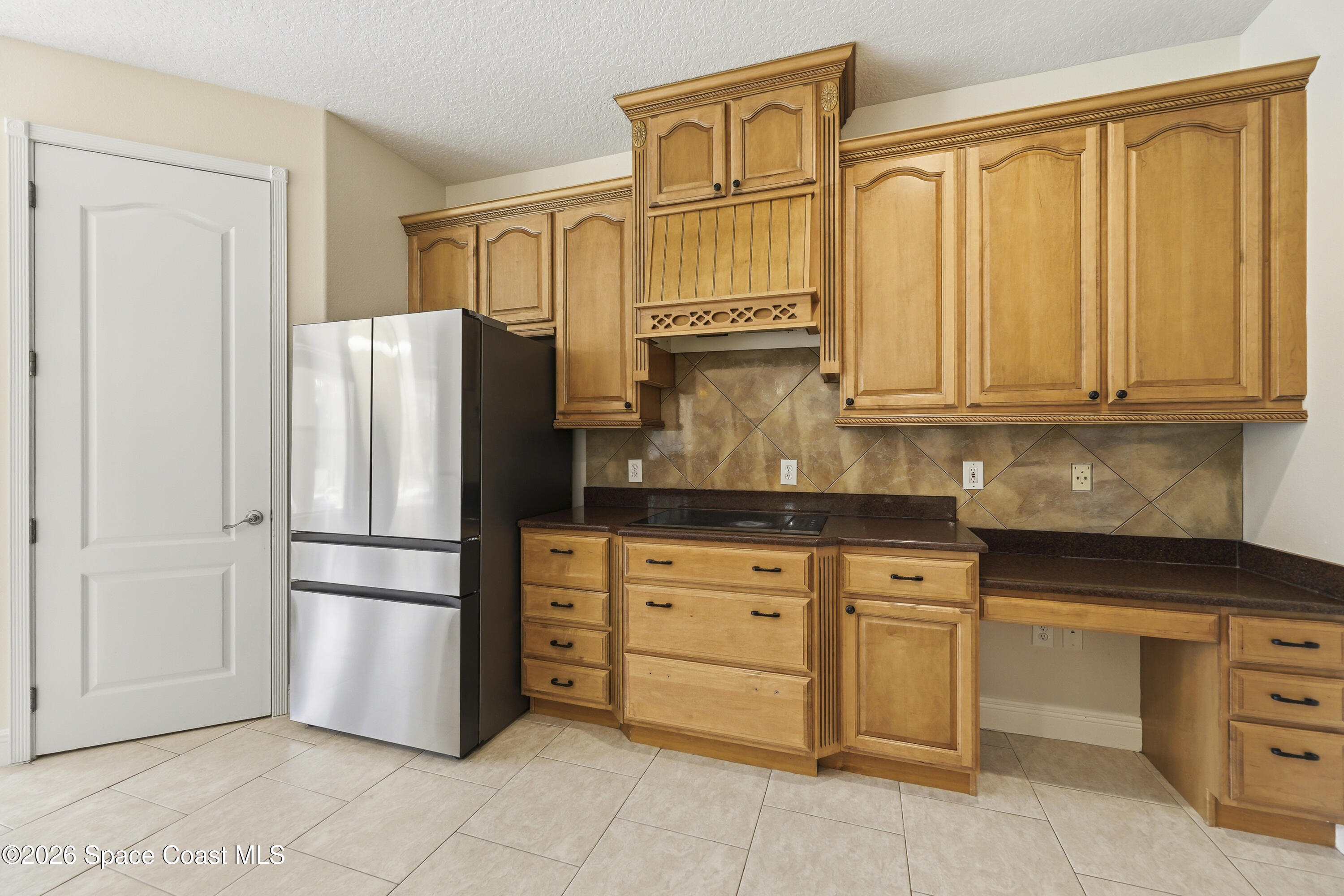2300 Duncil Lane Malabar, FL 32950 - Photo 23 of 86 a kitchen with stainless steel appliances granite countertop a refrigerator and cabinets