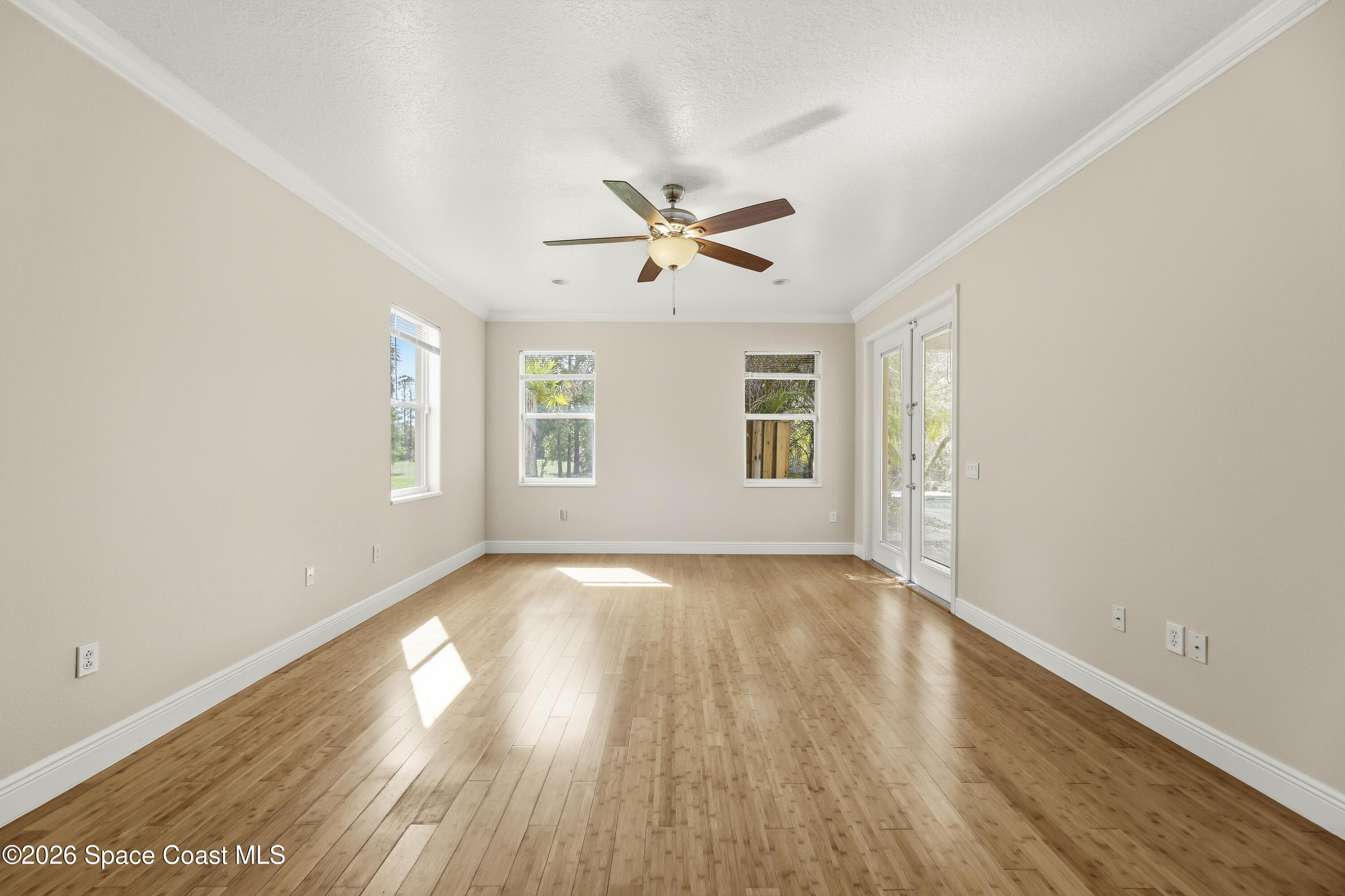 2300 Duncil Lane Malabar, FL 32950 - Photo 30 of 86 an empty room with wooden floor and windows