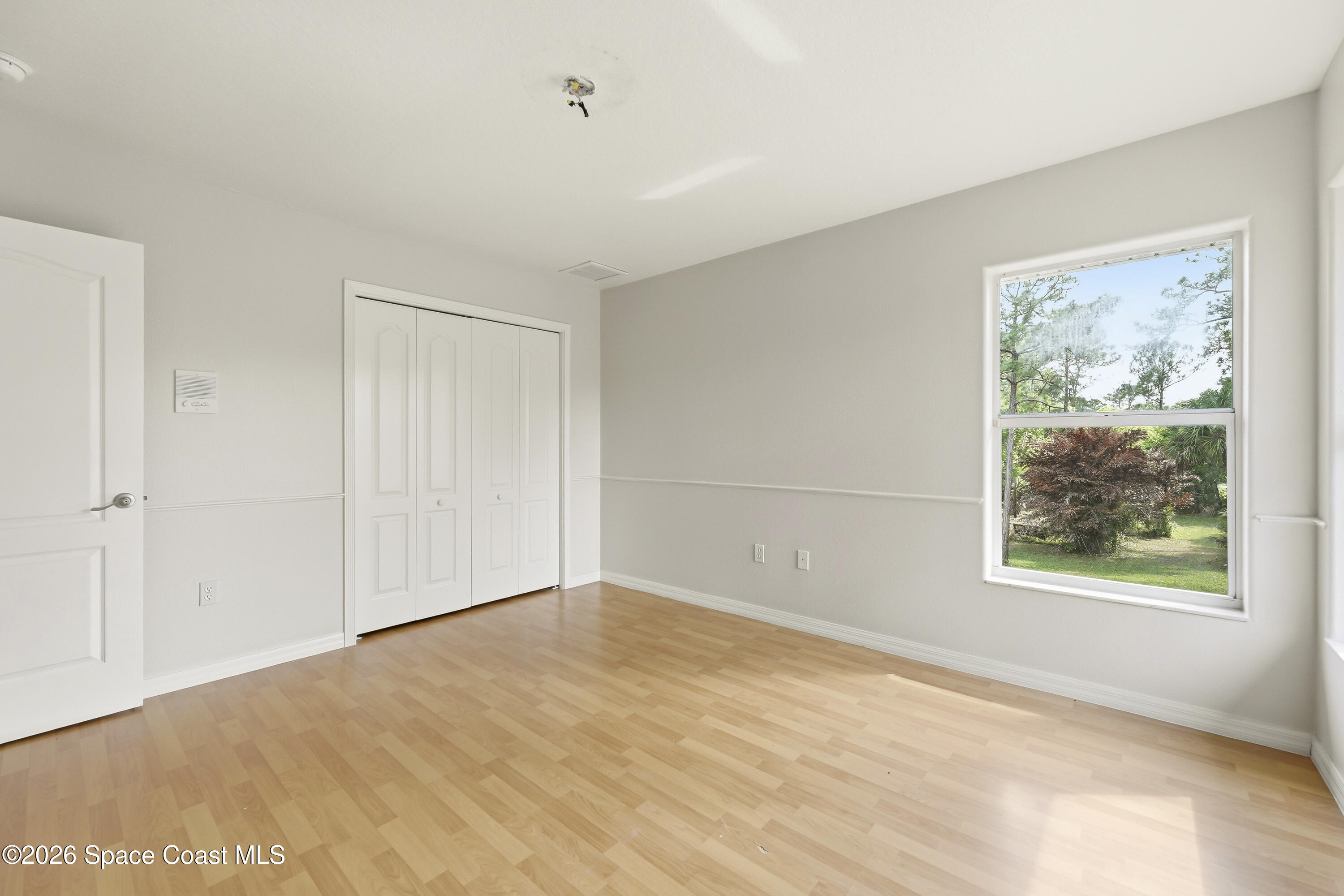 2300 Duncil Lane Malabar, FL 32950 - Photo 43 of 86 a view of an empty room with wooden floor and a window