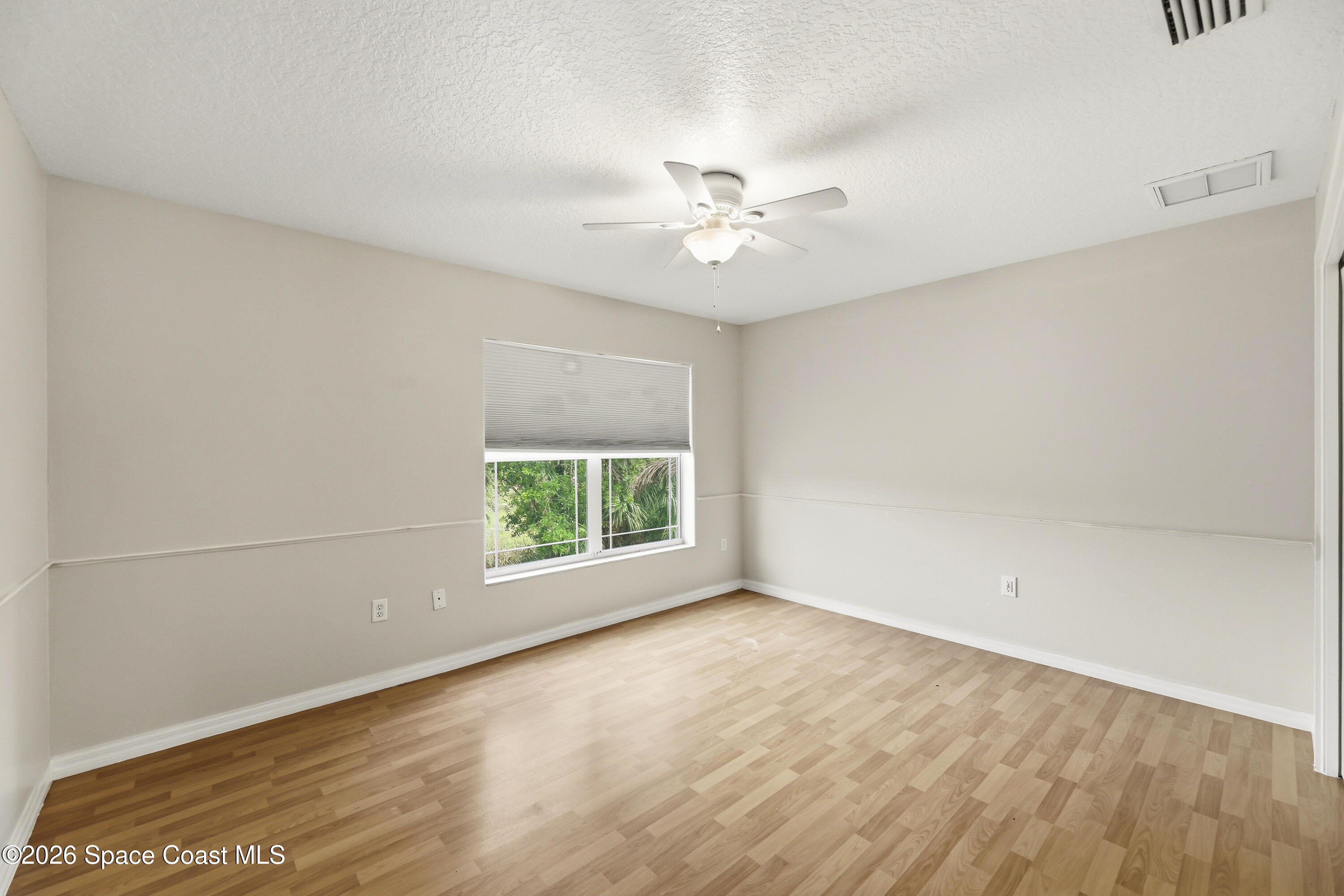 2300 Duncil Lane Malabar, FL 32950 - Photo 46 of 86 an empty room with a window and a ceiling fan