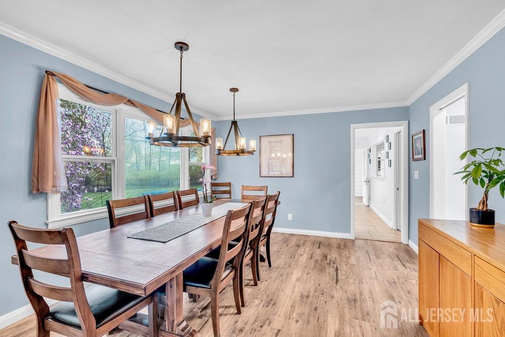 110 Springcrest Drive Hightstown, NJ 08520 - Photo 14 of 44 a dining room with furniture a chandelier and wooden floor