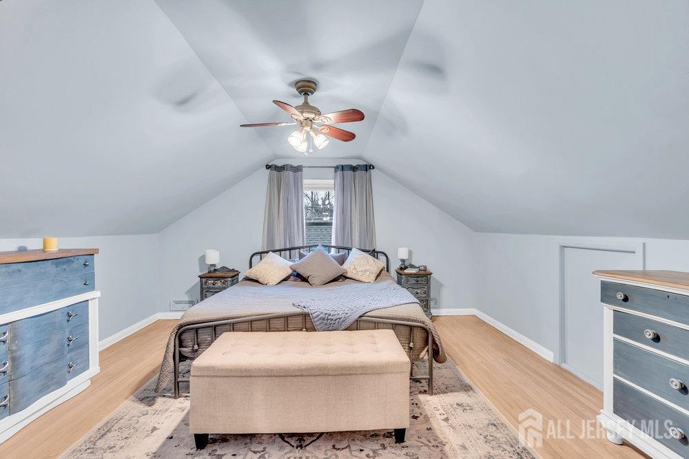 110 Springcrest Drive Hightstown, NJ 08520 - Photo 22 of 44 a bedroom with a bed and a chandelier