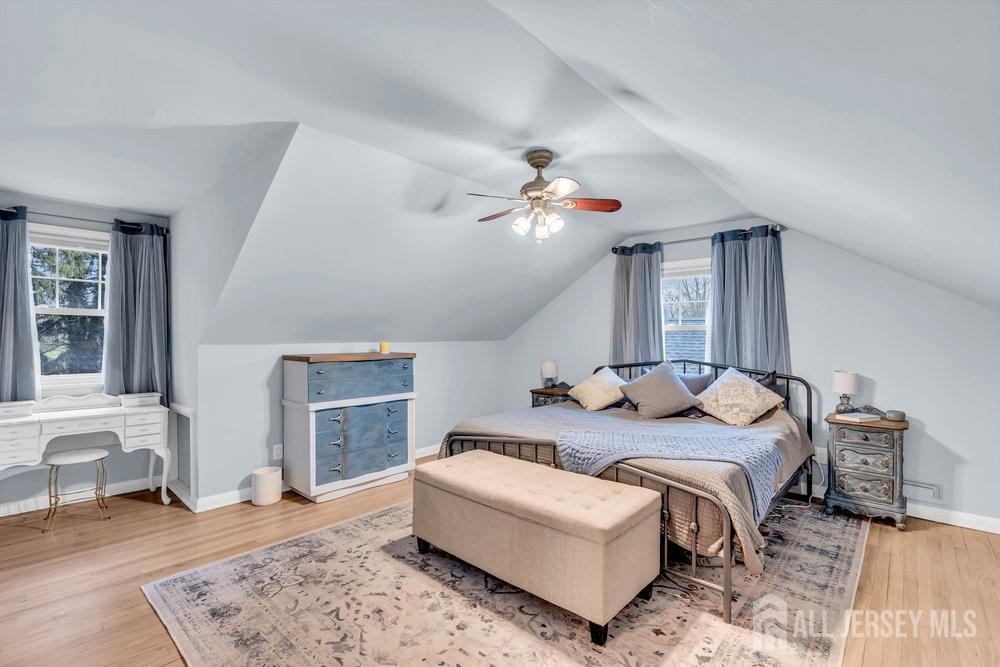 110 Springcrest Drive Hightstown, NJ 08520 - Photo 23 of 44 a spacious bedroom with a bed a couch and a fireplace