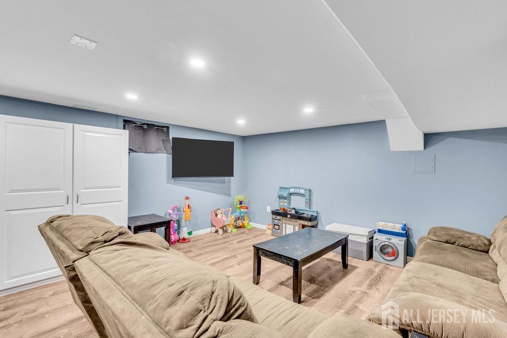 110 Springcrest Drive Hightstown, NJ 08520 - Photo 25 of 44 a living room with furniture and a flat screen tv