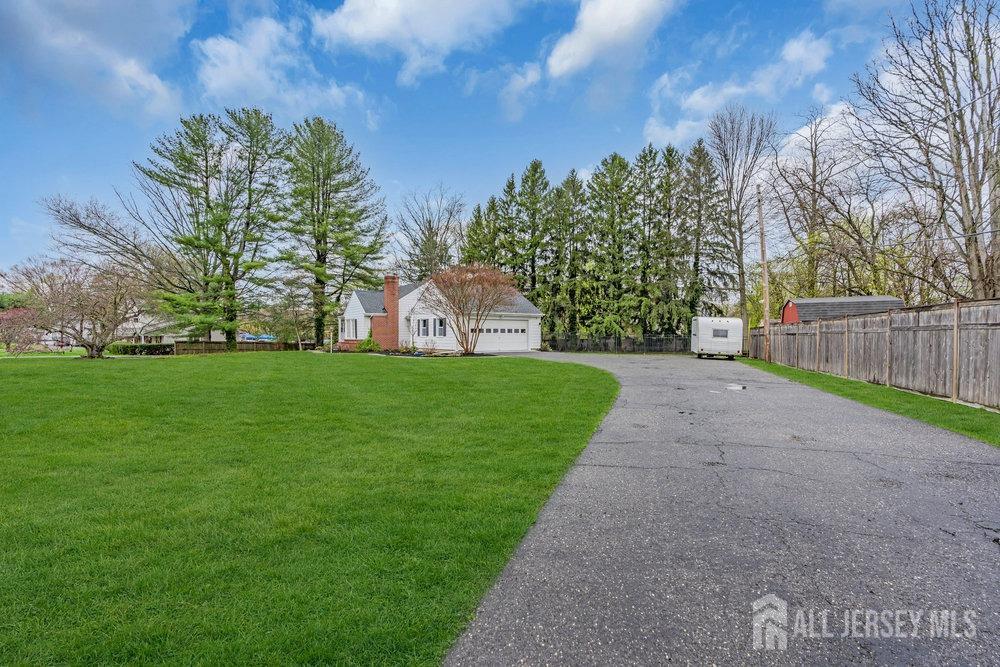 110 Springcrest Drive Hightstown, NJ 08520 - Photo 3 of 44 a view of green field with tree in the background