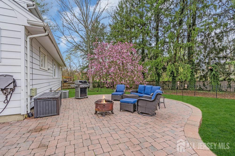 110 Springcrest Drive Hightstown, NJ 08520 - Photo 34 of 44 a backyard of a house with table and chairs