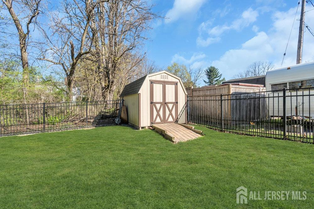 110 Springcrest Drive Hightstown, NJ 08520 - Photo 37 of 44 a view of a backyard with a garden and deck