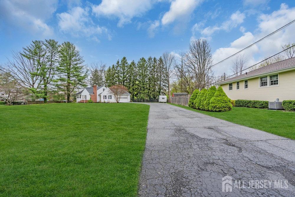 110 Springcrest Drive Hightstown, NJ 08520 - Photo 40 of 44 a view of a garden with a building in the background