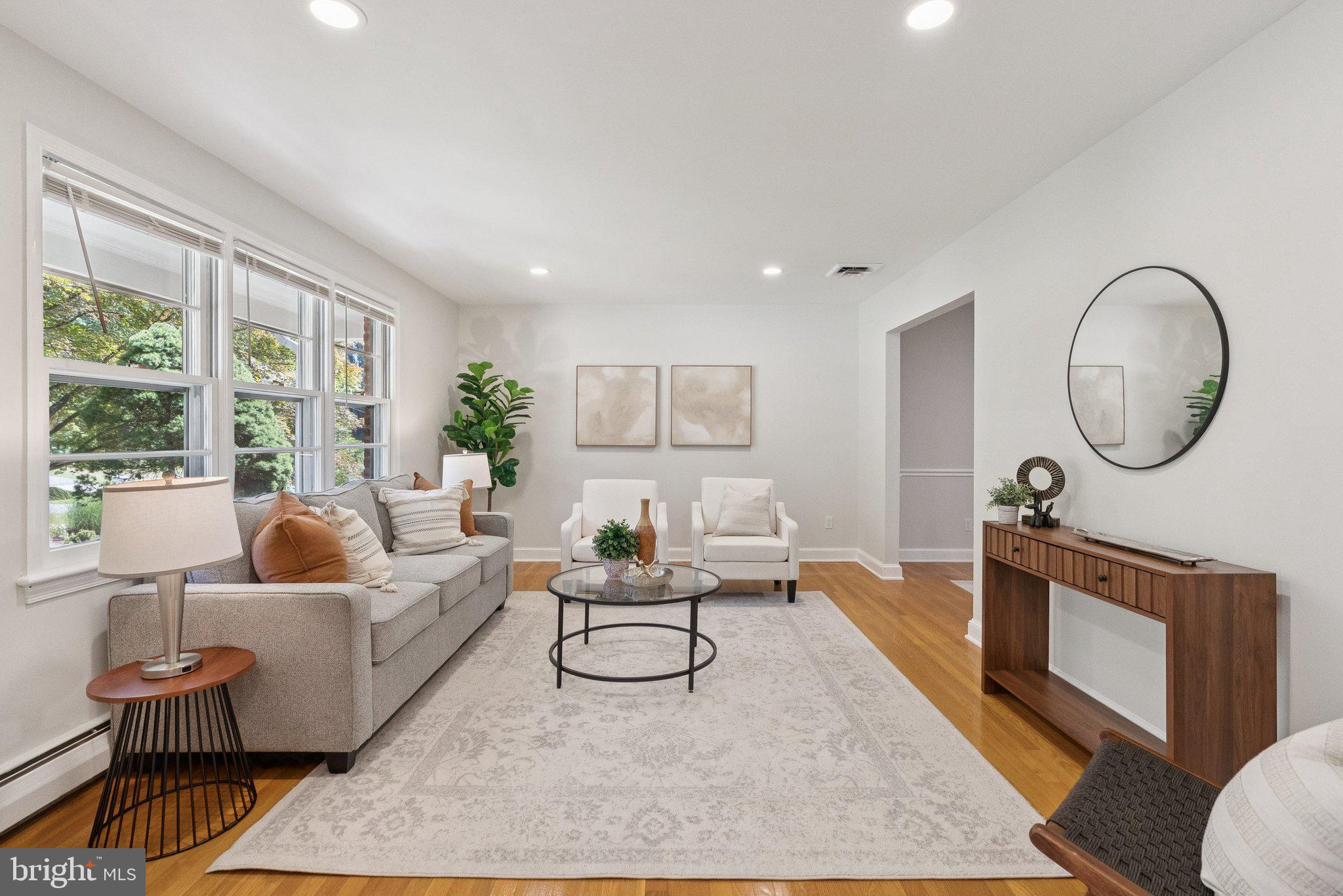 111 Marine Terrace Silver Spring, MD 20905 - Photo 5 of 40 a living room with furniture a rug a lamp and a large window