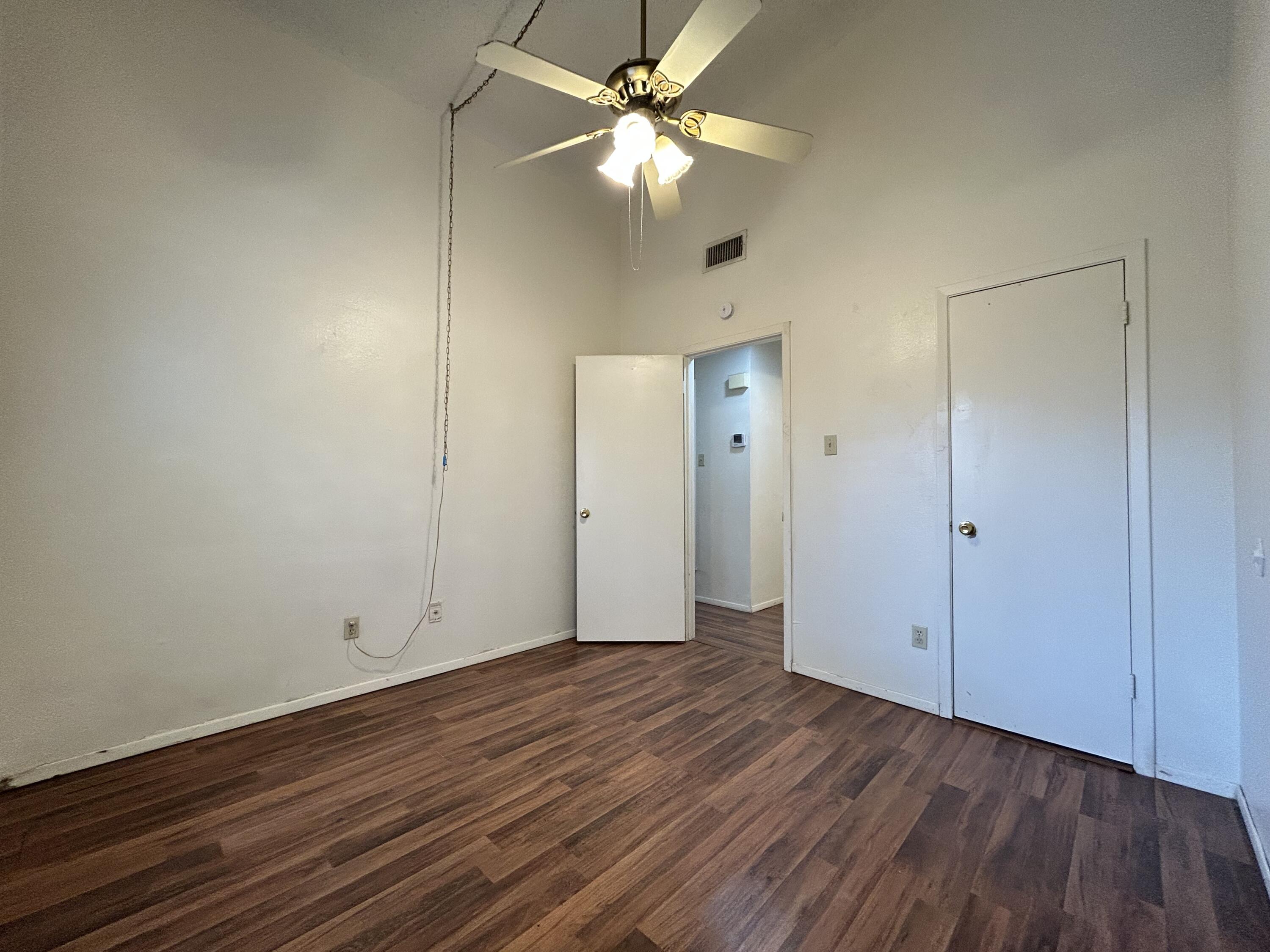 139 North Troy Avenue, Unit B Lubbock, TX 79416 - Photo 7 of 9 a view of an empty room with wooden floor