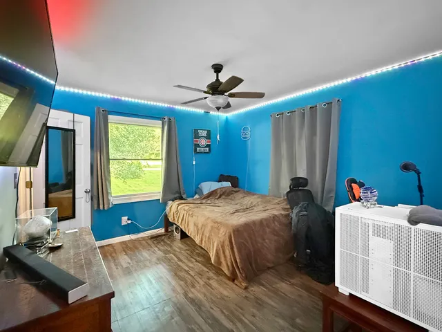 a bedroom with bed and a window