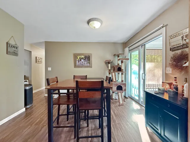 a view of a dining room with furniture and wooden floor
