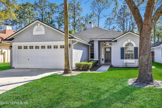 a front view of house with yard and green space