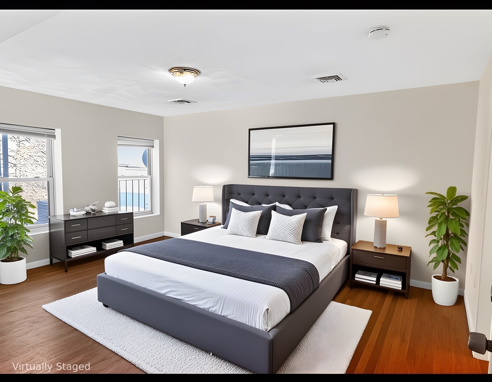 12 Paris Street, Unit 3 Boston, MA 02128 - Photo 2 of 7 a spacious bedroom with a bed and a couch