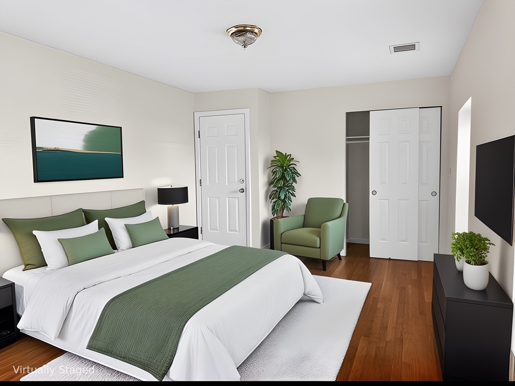 12 Paris Street, Unit 3 Boston, MA 02128 - Photo 3 of 7 a bedroom with a bed and a flat screen television