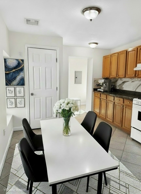 12 Paris Street, Unit 3 Boston, MA 02128 - Photo 5 of 7 a view of a dining room with furniture and wooden floor