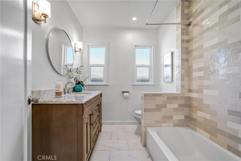1925 Lundy Avenue Pasadena, CA 91104 - Photo 21 of 47 a bathroom with a granite countertop sink a toilet and a bathtub