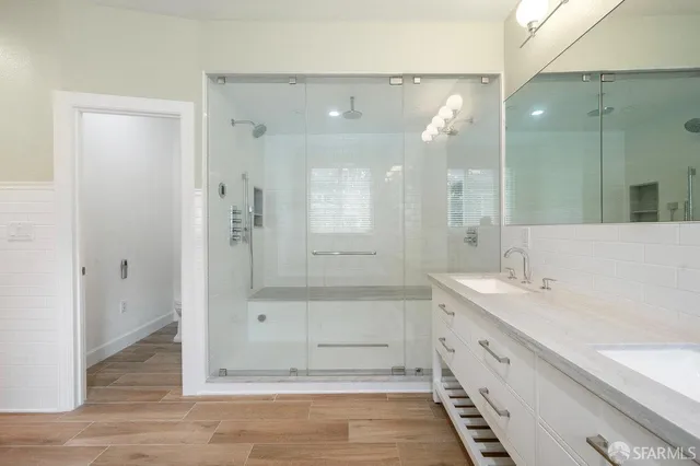 a bathroom with a bathtub shower sink and mirror