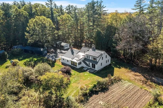 a aerial view of a house with a yard basket ball court and outdoor seating