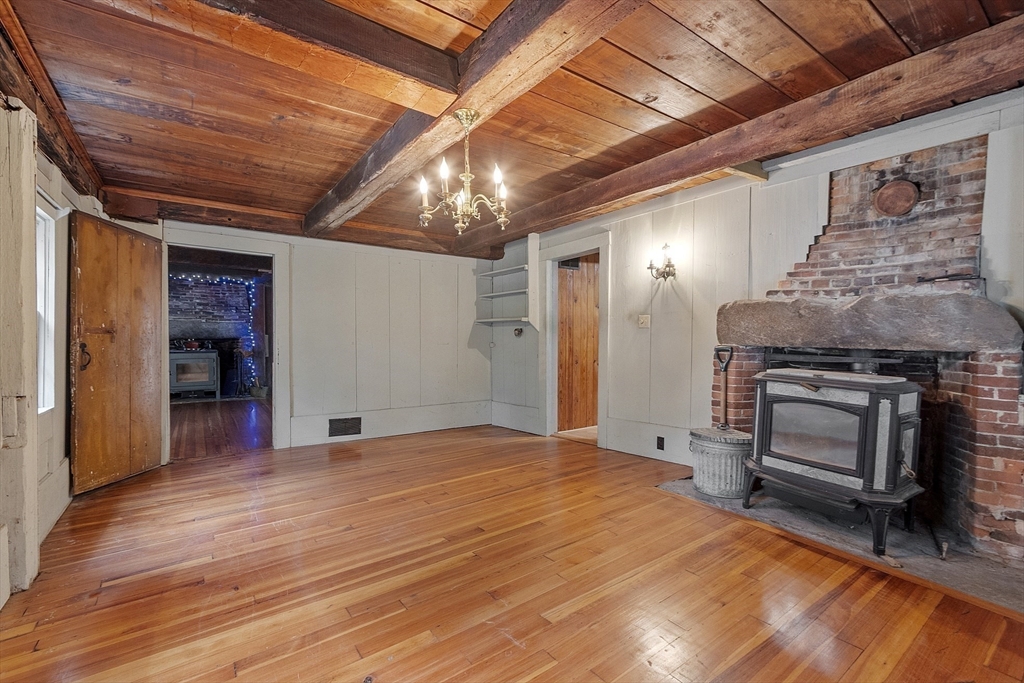 350 Athol-Richmond Road Royalston, MA 01368 - Photo 12 of 40 a view of empty room with wooden floor and fireplace