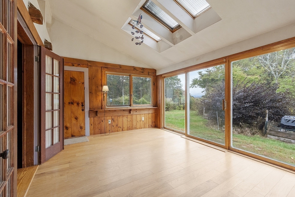 350 Athol-Richmond Road Royalston, MA 01368 - Photo 14 of 40 a view of an empty room with wooden floor and a window