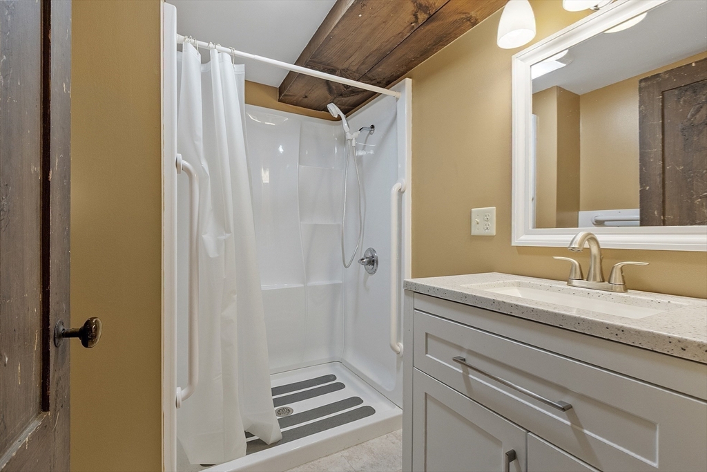 350 Athol-Richmond Road Royalston, MA 01368 - Photo 15 of 40 a bathroom with a granite countertop sink a mirror a vanity and a shower