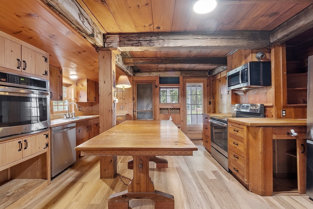 350 Athol-Richmond Road Royalston, MA 01368 - Photo 19 of 40 a large kitchen with stainless steel appliances wooden floor a stove and a refrigerator