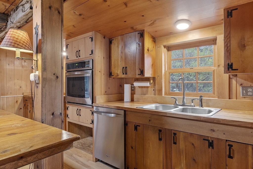 350 Athol-Richmond Road Royalston, MA 01368 - Photo 20 of 40 a kitchen with kitchen island granite countertop a sink appliances cabinets and counter space
