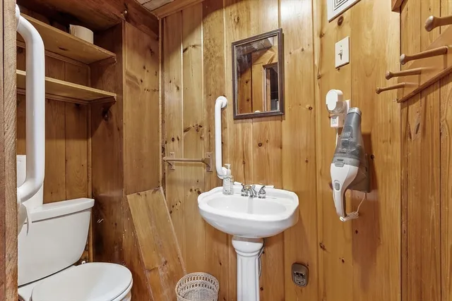 a bathroom with a toilet sink and mirror