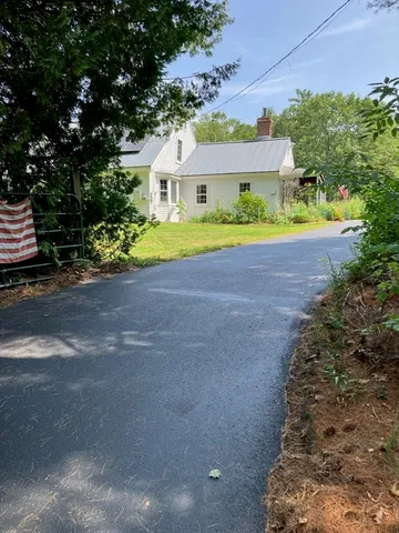a house with swimming pool in front of it