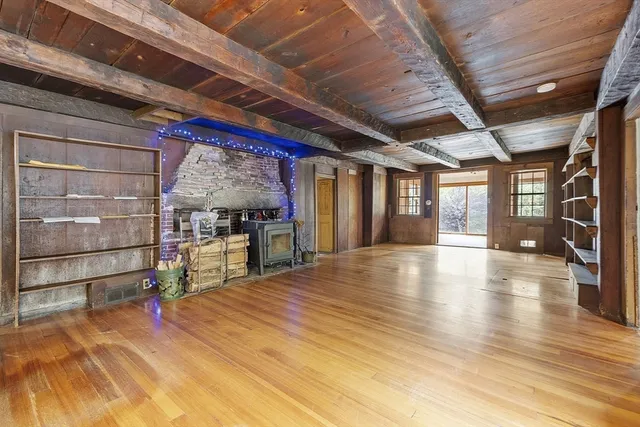a view of a room with wooden floor