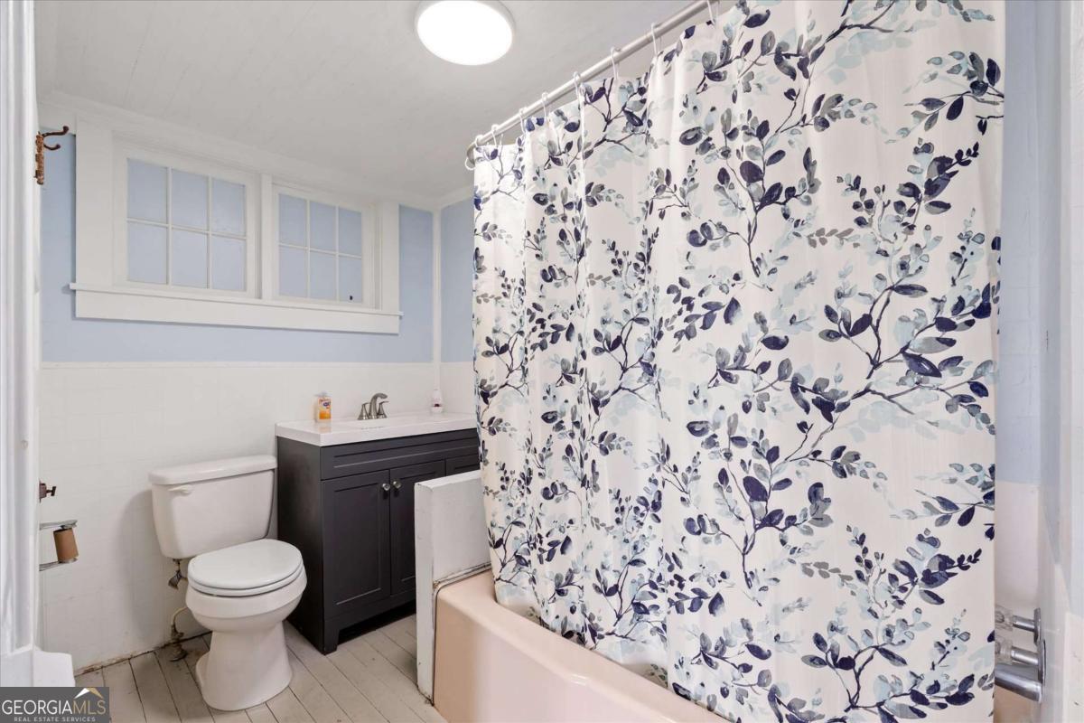 3608 Us Highway Buchanan, GA 30113 - Photo 30 of 51 a bathroom with a toilet and a shower curtain