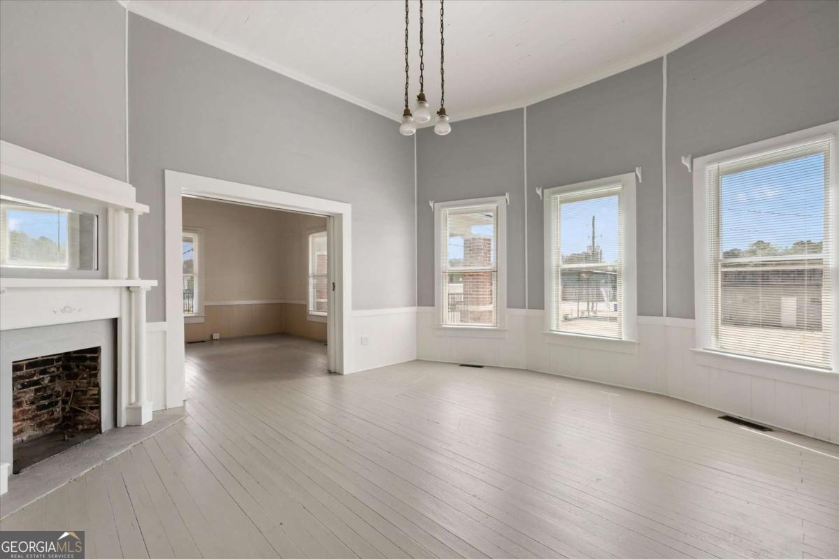 3608 Us Highway Buchanan, GA 30113 - Photo 32 of 51 an empty room with wooden floor fireplace and windows