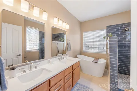 a spacious bathroom with sink and mirror