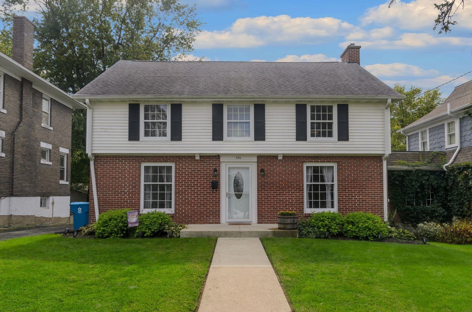 736 East 3rd Street Dixon, IL 61021 - Photo 1 of 29 a front view of a house with a garden and yard