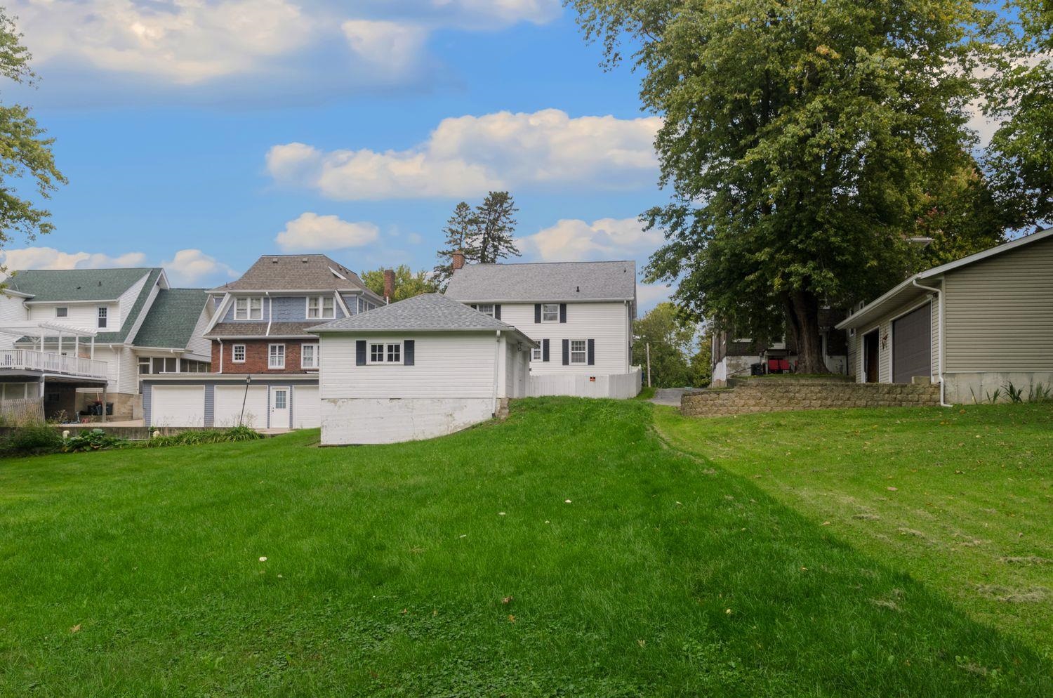 736 East 3rd Street Dixon, IL 61021 - Photo 25 of 29 a view of a house with a big yard potted plants and large tree