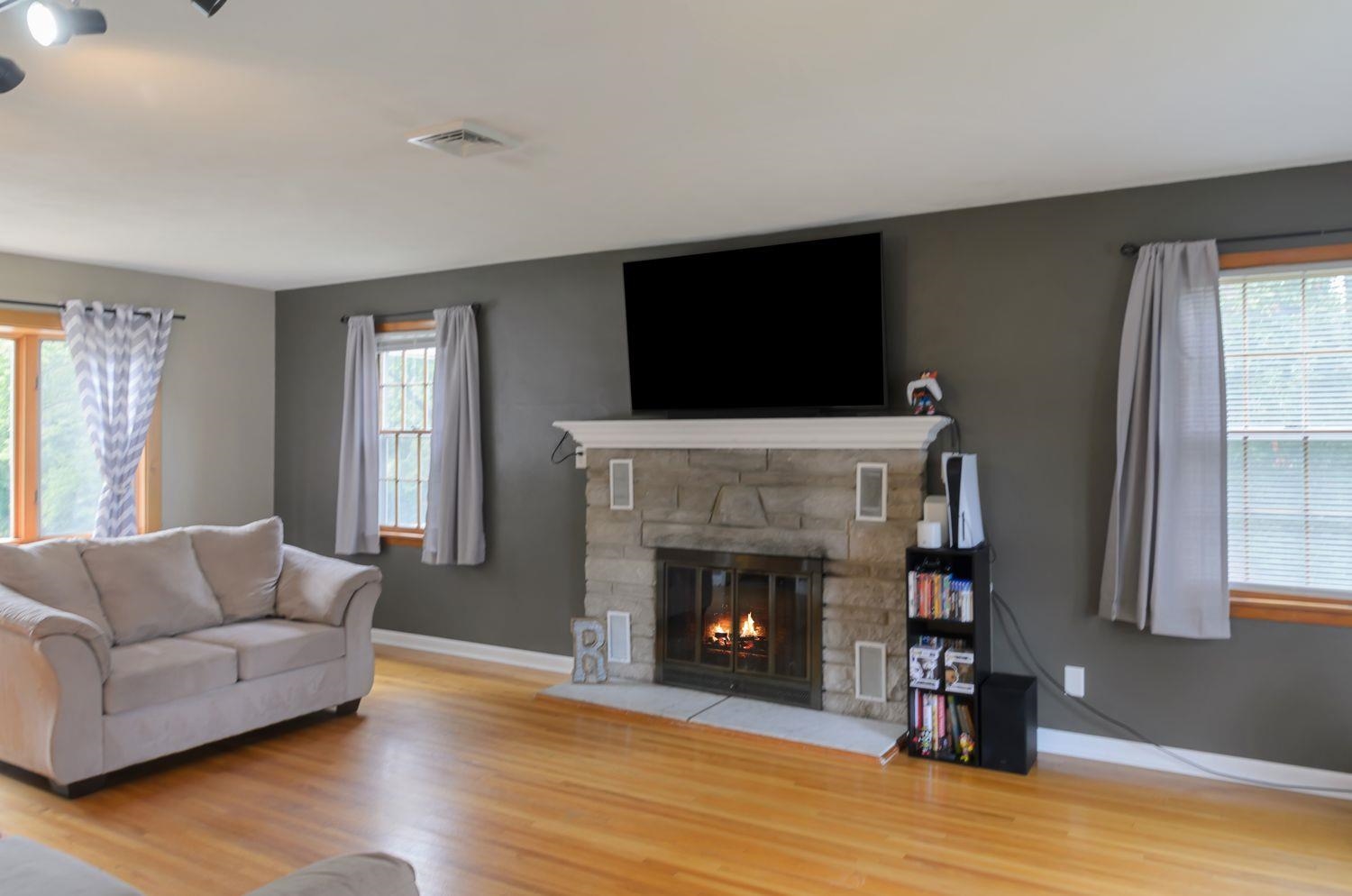 736 East 3rd Street Dixon, IL 61021 - Photo 5 of 29 a living room with furniture a flat screen tv and a fireplace