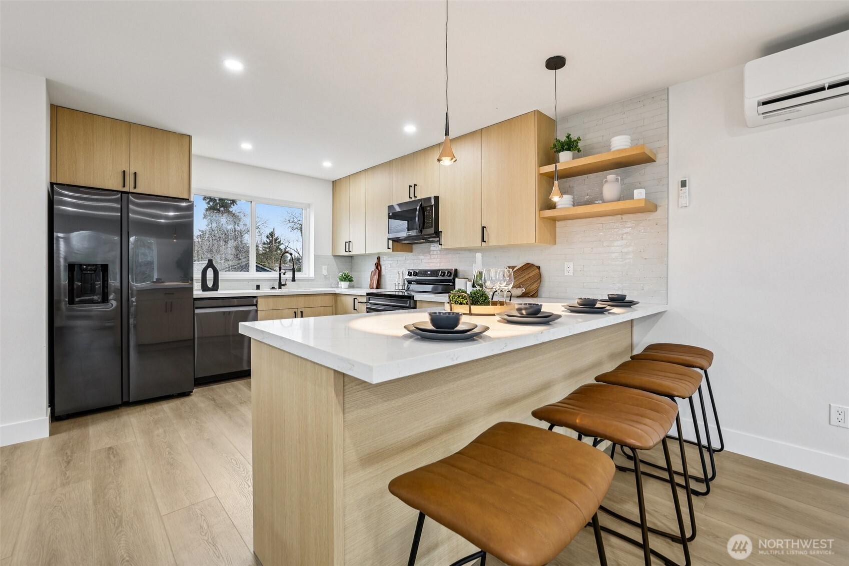 7719 Renton Avenue South, Unit A Seattle, WA 98118 - Photo 16 of 35 a kitchen with a sink stainless steel appliances and white cabinets