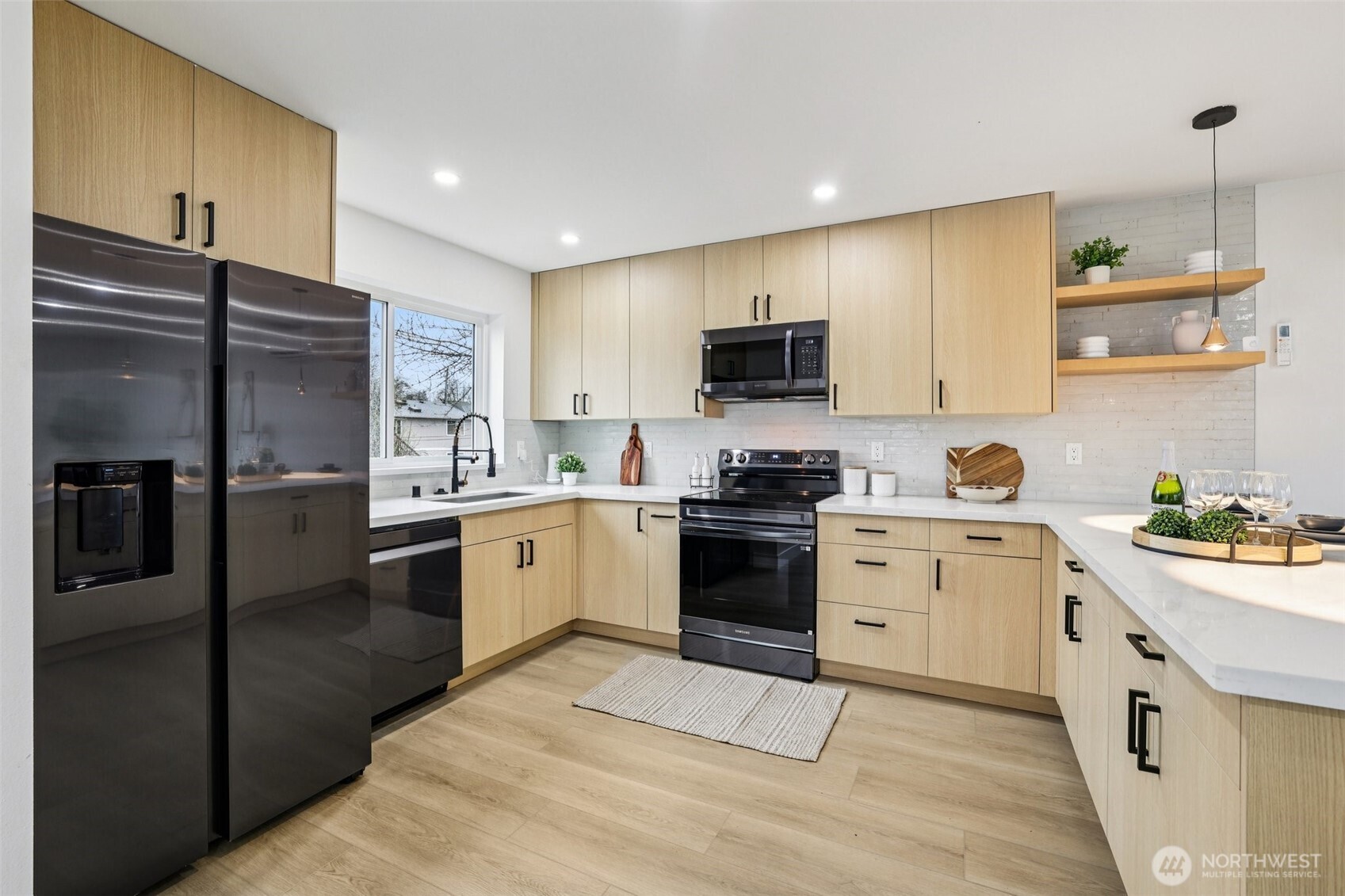 7719 Renton Avenue South, Unit A Seattle, WA 98118 - Photo 17 of 35 a kitchen with a sink stove and refrigerator