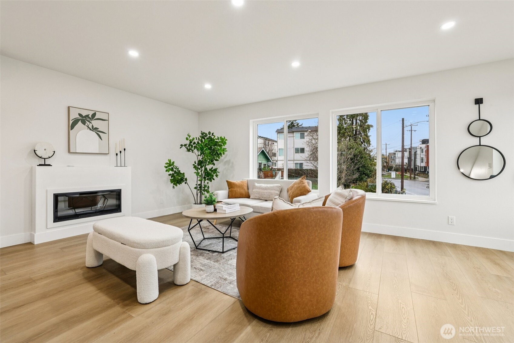 7719 Renton Avenue South, Unit A Seattle, WA 98118 - Photo 10 of 35 a living room with furniture a fireplace and a floor to ceiling window