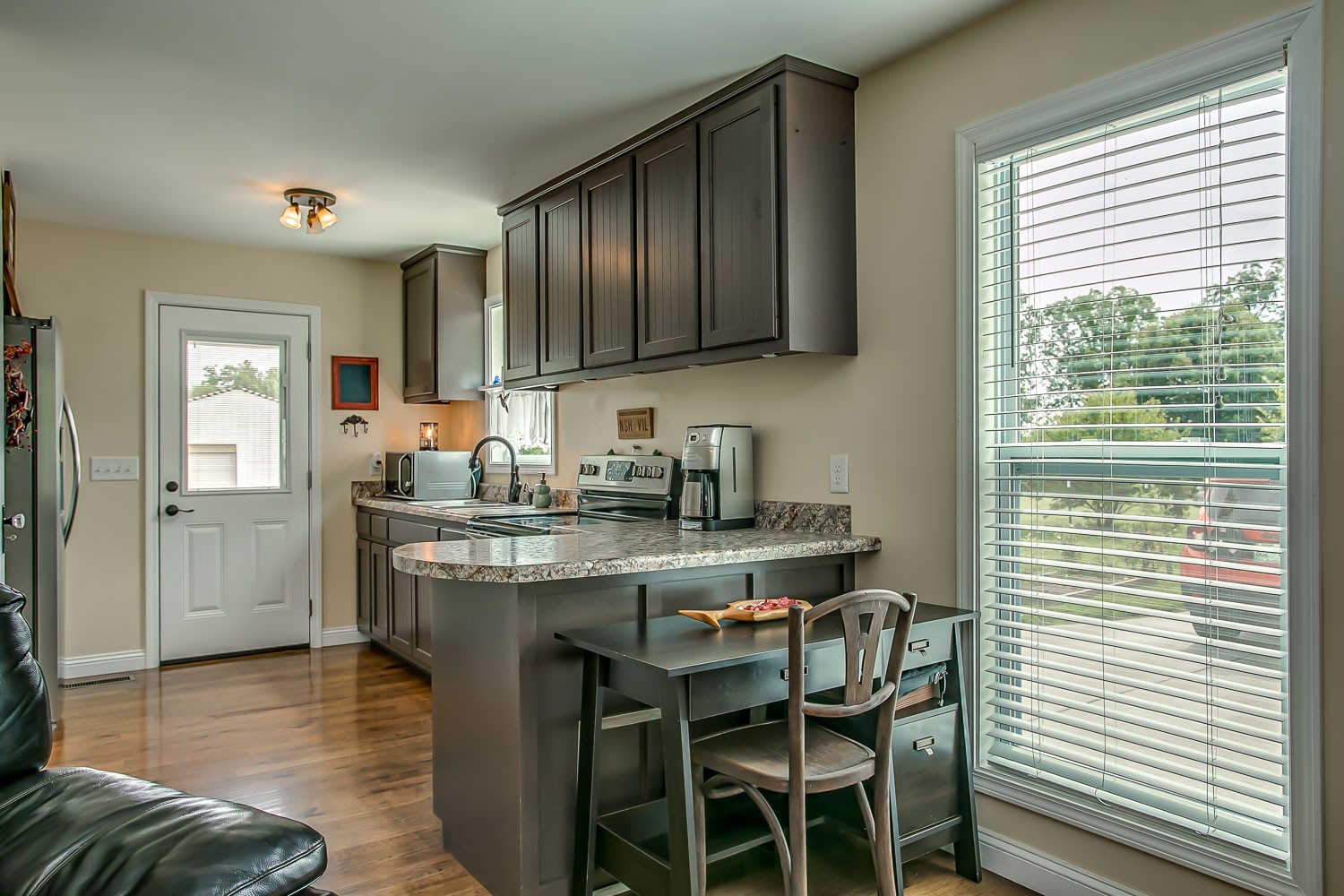 5620 Hargrove Road Franklin, TN 37064 - Photo 9 of 49 a kitchen with stainless steel appliances granite countertop wooden cabinets a dining table and chairs