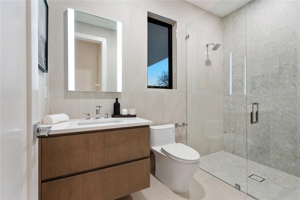 519 Rountree Drive Longboat Key, FL 34228 - Photo 59 of 88 a bathroom with a sink a toilet and shower