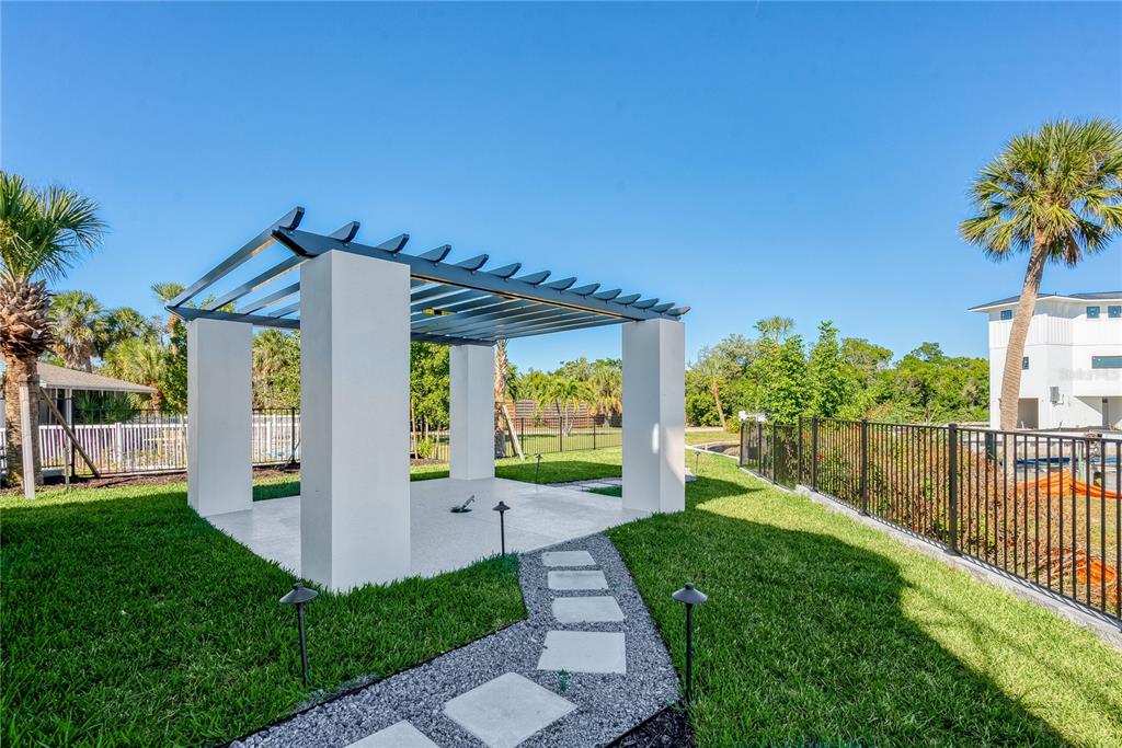 519 Rountree Drive Longboat Key, FL 34228 - Photo 65 of 88 a view of a house with a small yard and a garden