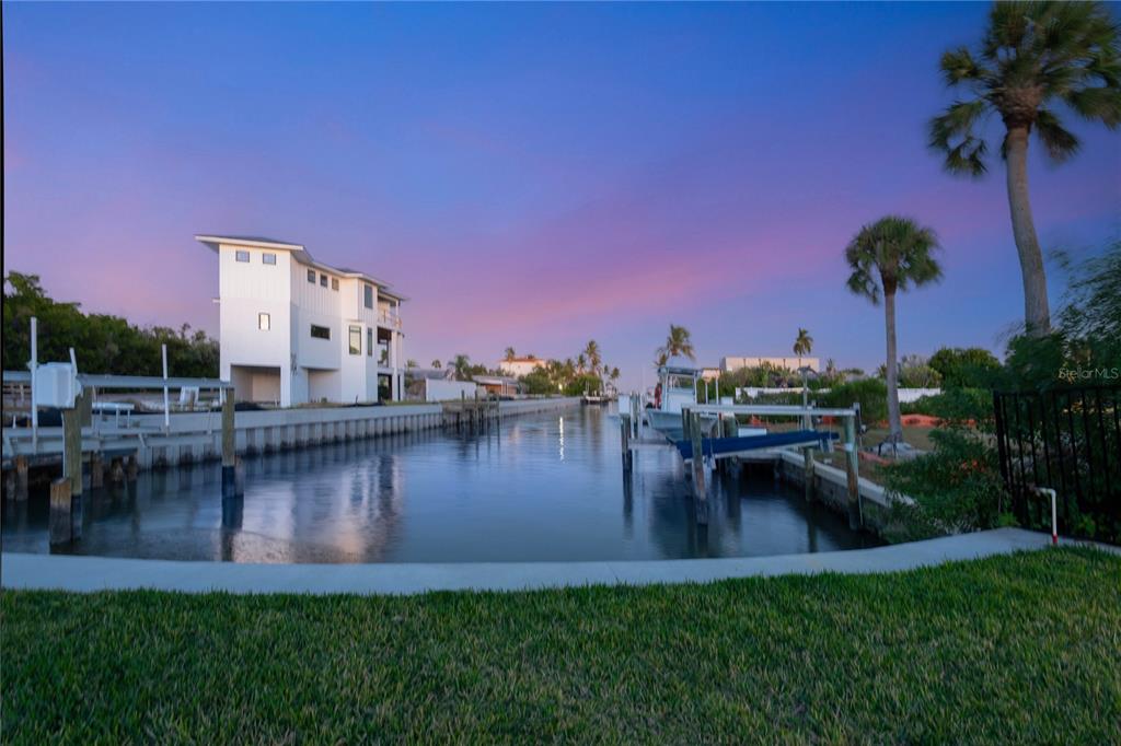 519 Rountree Drive Longboat Key, FL 34228 - Photo 73 of 88 a view of a lake with a house in the background