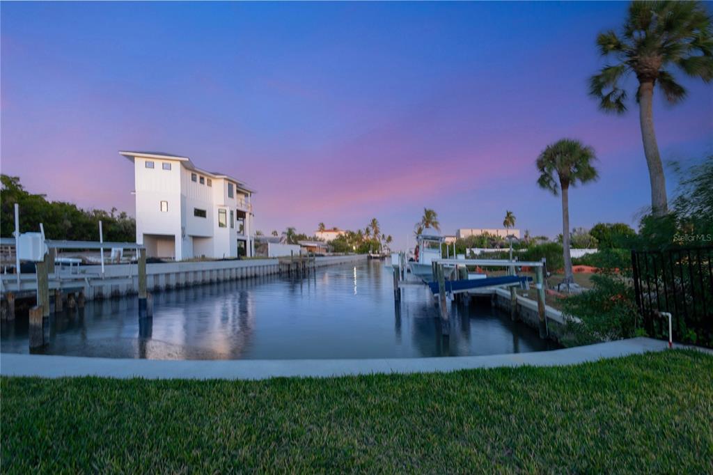 519 Rountree Drive Longboat Key, FL 34228 - Photo 74 of 88 a view of a lake with a house in the background
