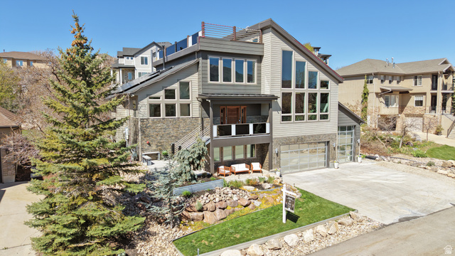14902 Saddle Leaf Court Draper, UT 84020 - Photo 1 of 52 Contemporary house with stone siding, concrete driveway, a garage, and a residential view