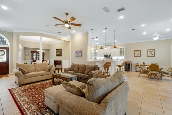 a dining room with furniture a chandelier and a rug